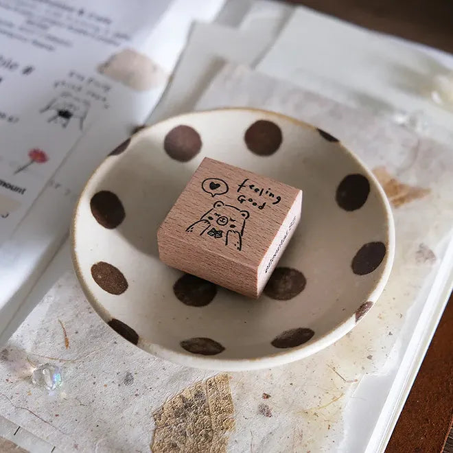Wooden stamp with a bear design on a polka dot dish