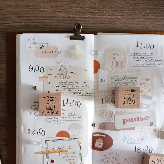 Planner decorated with Beary Ordinary Days 01 stamp prints and notes on a wooden surface