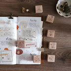 Open notebook with stamps on a wooden surface
