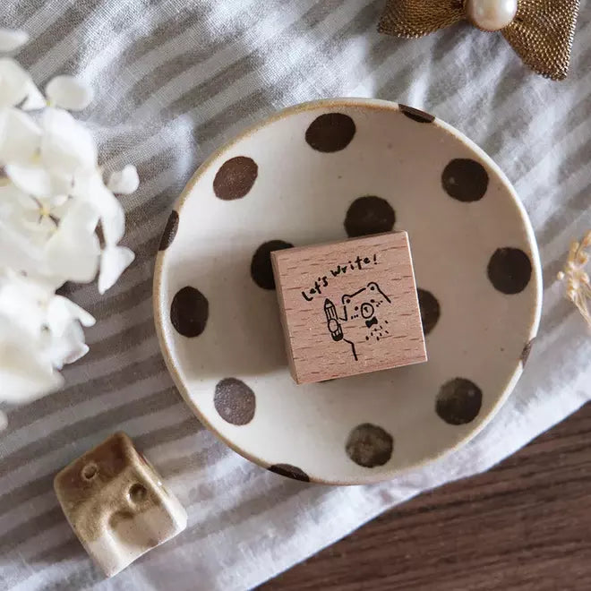 Beary Ordinary Days 03 stamp in a polka dot ceramic dish on a striped fabric background