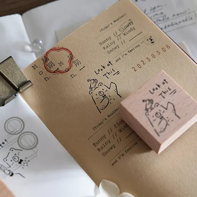 Pink rubber stamp with cartoon design on a notebook