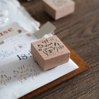 Wooden stamp with illustrations on a wooden surface