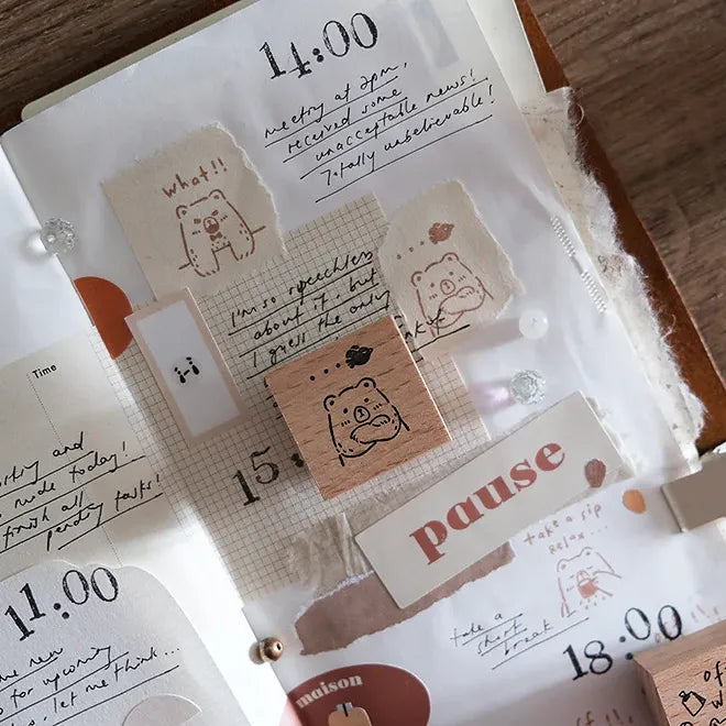 Close-up of a planner with stickers and notes on a wooden surface