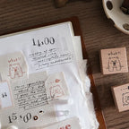Notebook with handwritten text and rubber stamps on a wooden surface