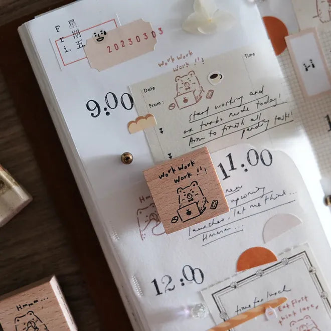 Planner with stickers and notes on a wooden surface