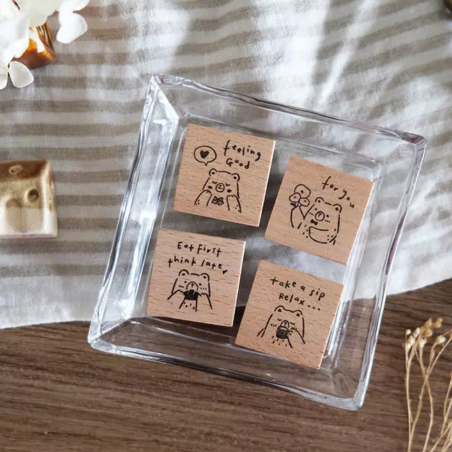 Set of Beary Ordinary Days 02 wooden stamps in a glass dish on a striped fabric background
