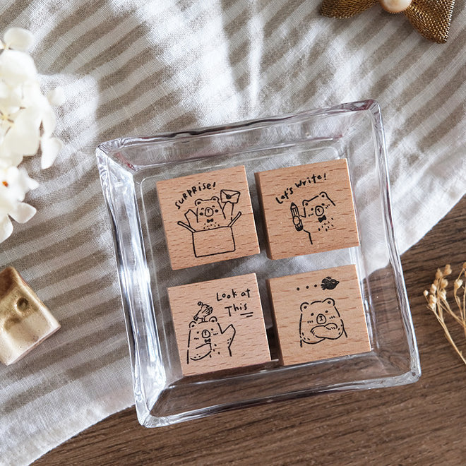 Four Beary Ordinary Days 03 wooden stamps gathered in a glass dish on striped fabric