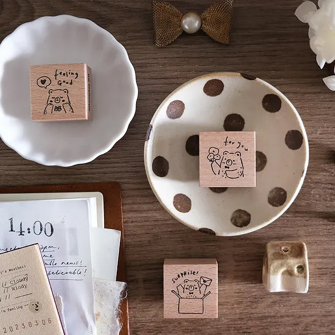Wooden stamps with animal illustrations on a wooden surface with decorative items.