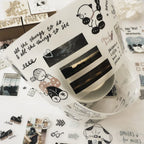 Decorative tape with black and white designs on a patterned background