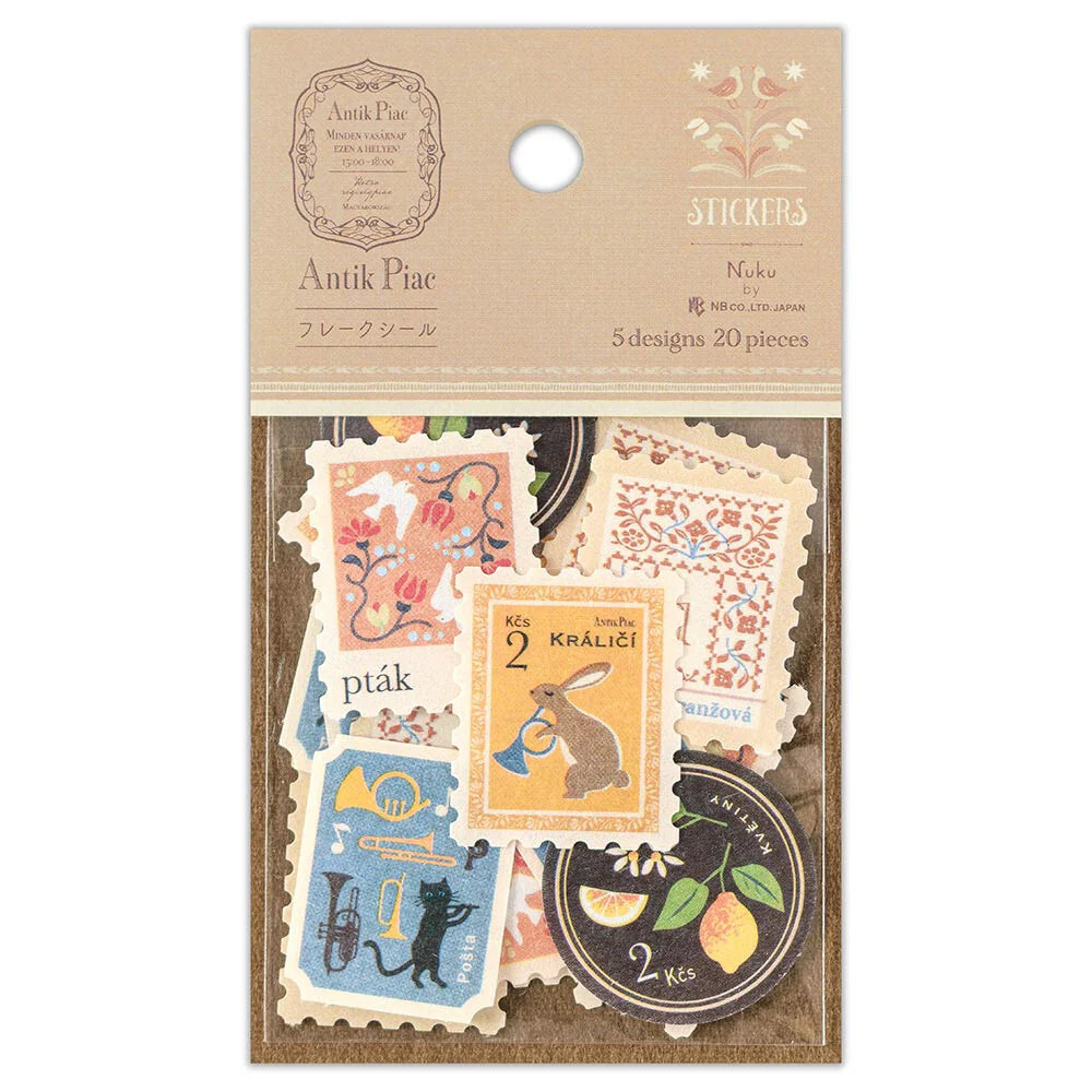 Antik Piac Vintage Style Postage Flake Stickers in packaging on a warm brown background