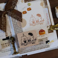 Stationery set with rubber stamps, a ribbon, and a wax seal on a white surface.