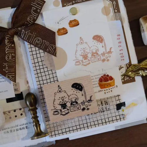 Stationery set with rubber stamps, a ribbon, and a wax seal on a white surface.