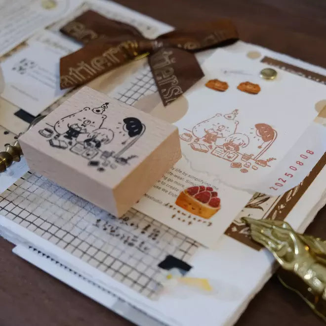 Blissful Days rubber stamps with cute bear and girl designs on a wooden block and paper backdrop