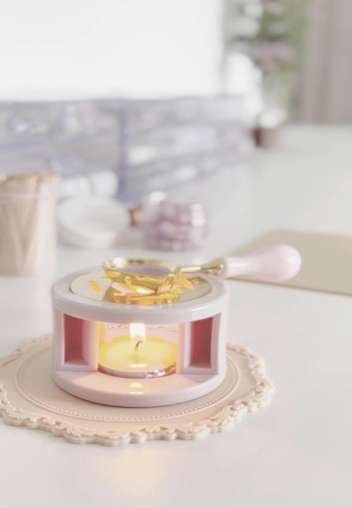 Decorative candle holder with a small candle inside on a white surface.