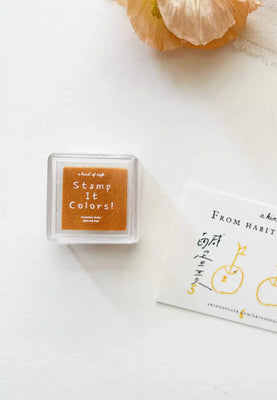 Rectangular stamp pad with 'Stamp It Colors!' text on a white background