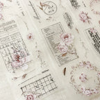 Decorative paper with floral and script designs on a textured background