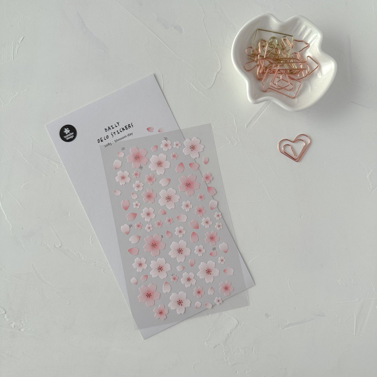 Floral sticker sheet with a dish of paper clips on a light grey background, from the Blossom Day Sticker Sheet