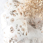 Floral-patterned fabric with dried flowers on a white background