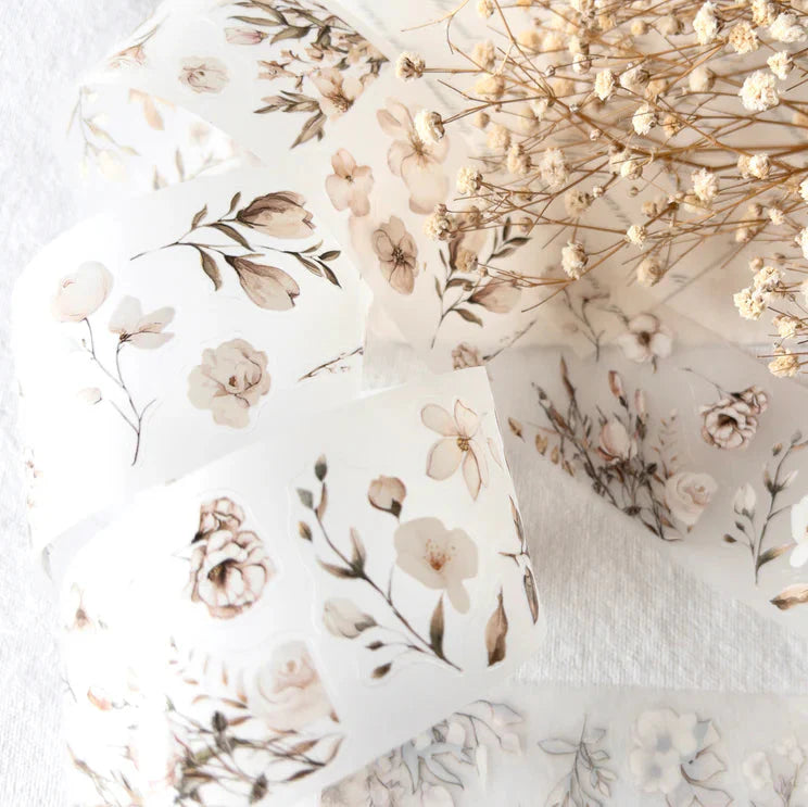 Blossoming PET Tape botanical pattern laid flat with dried flowers on a white background