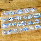 Vintage-inspired blue illustration stickers featuring girls and home objects placed on paper and translucent sheets