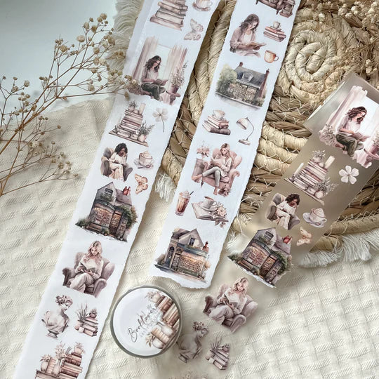 Book Lover PET Tape sticker sheets with figures and bookshop buildings arranged on a textured surface