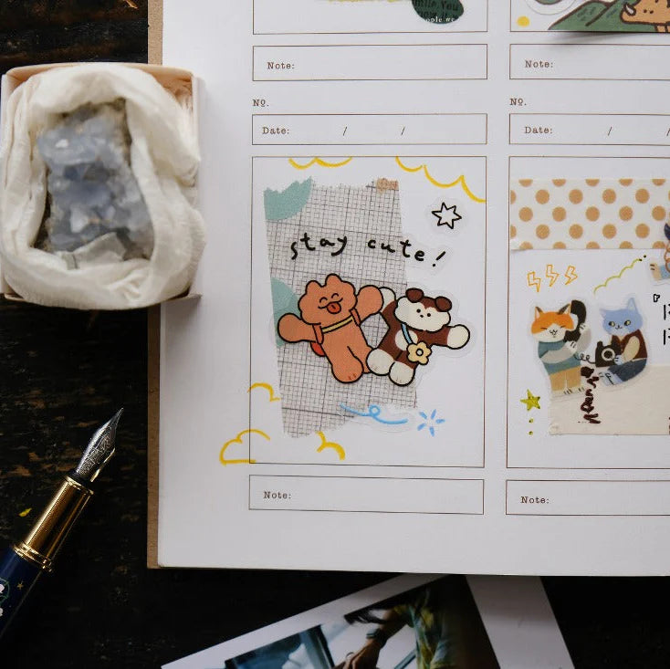 Brick Notes Notebook with cute animal illustrations beside a fountain pen on wood
