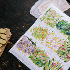 Sheet of floral stamps on a wooden surface