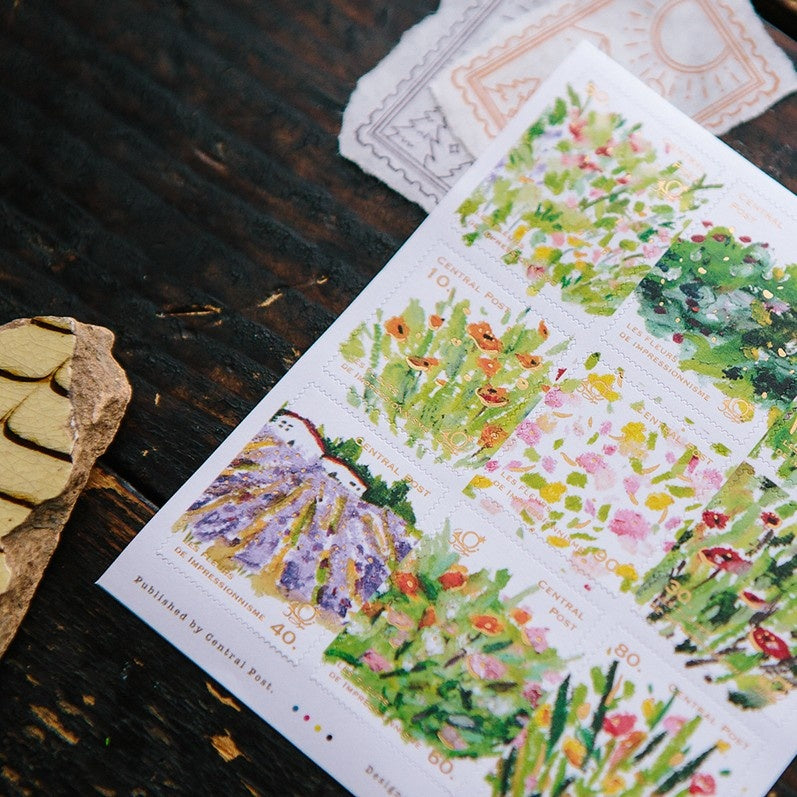 Sheet of floral stamps on a wooden surface