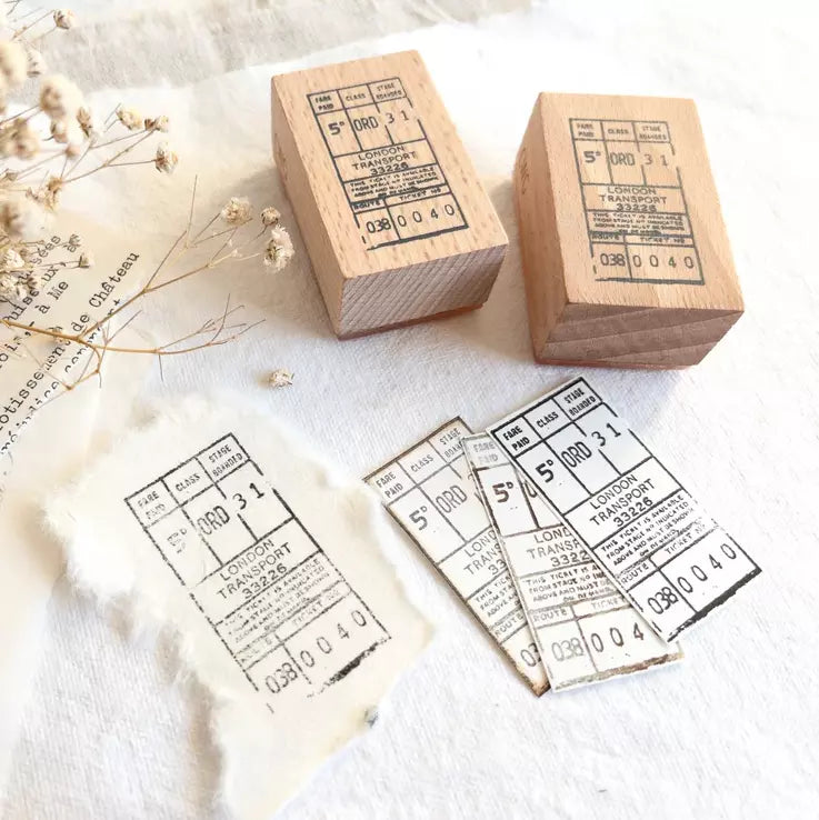 Two wooden Bus Ticket Rubber Stamps with transit ticket designs on a light background