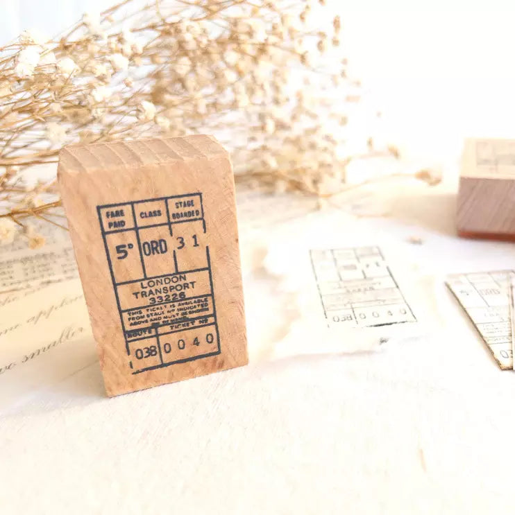 Bus Ticket Rubber Stamp vintage label print styled on a small cardboard box on light