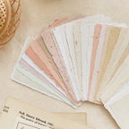 Set of color swatches arranged in a fan shape on a textured surface.