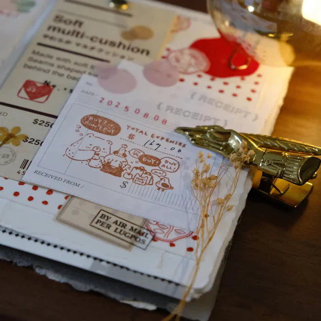 Buy or Bye rubber stamp receipt impression styled with a gold-wrapped chocolate bar on wood