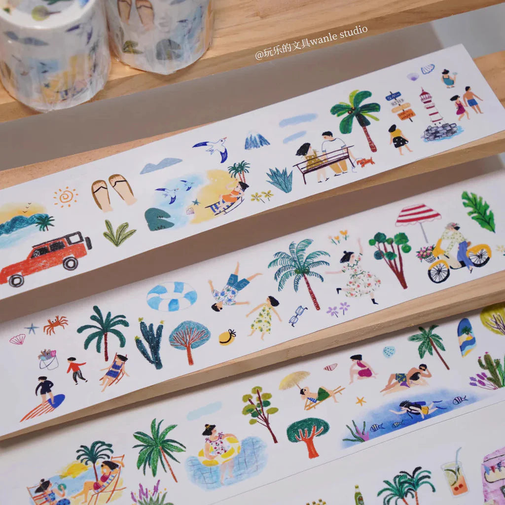 Set of colorful illustrated washi tape rolls on a wooden surface.