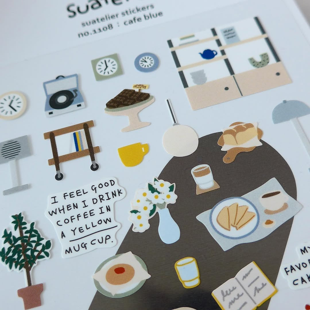 Stickers of a table with food and drinks, a clock and other objects, from the Café Blue Sticker Sheet