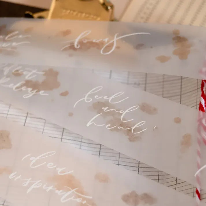 Clear Dream Time Calligraphy PET Tape sheets with text and floral designs on a soft-focus background