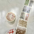 Decorative washi tape with floral and geometric designs on a white surface