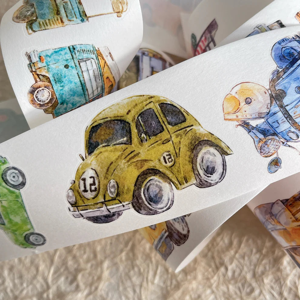 Roll of Car A52 PET Tape with its colorful car illustrations resting on a textured surface