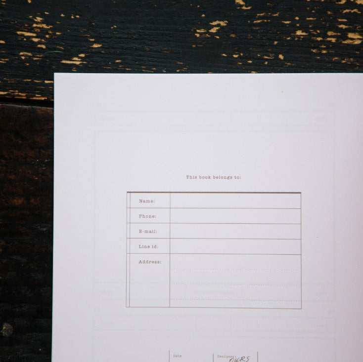 Card Folder Notebook inner page with a printed form layout shown on a dark wooden surface