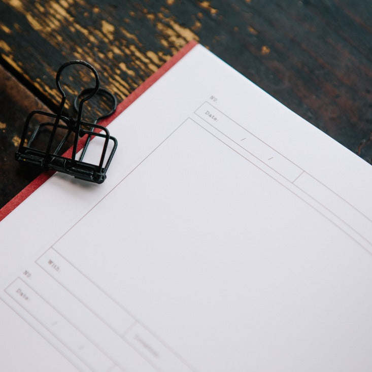 Open Card Folder Notebook showing its square section pages on a warm wooden surface