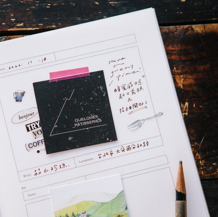 Open Card Folder Notebook with a black square card placed on top, on a wooden surface