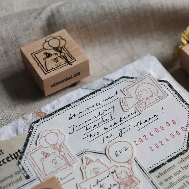 Bear and Girl Celebration Rubber Stamp with a bear holding balloons on a textured surface