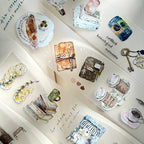 Collection of miniature items including books, a teacup, and decorative objects on a white surface.