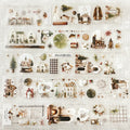 Collection of decorative items including houses, trees, and other ornaments on a textured white background.