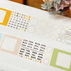 Planner sticker sheet with monthly calendar layout, pastel color blocks, and dotted circle frames