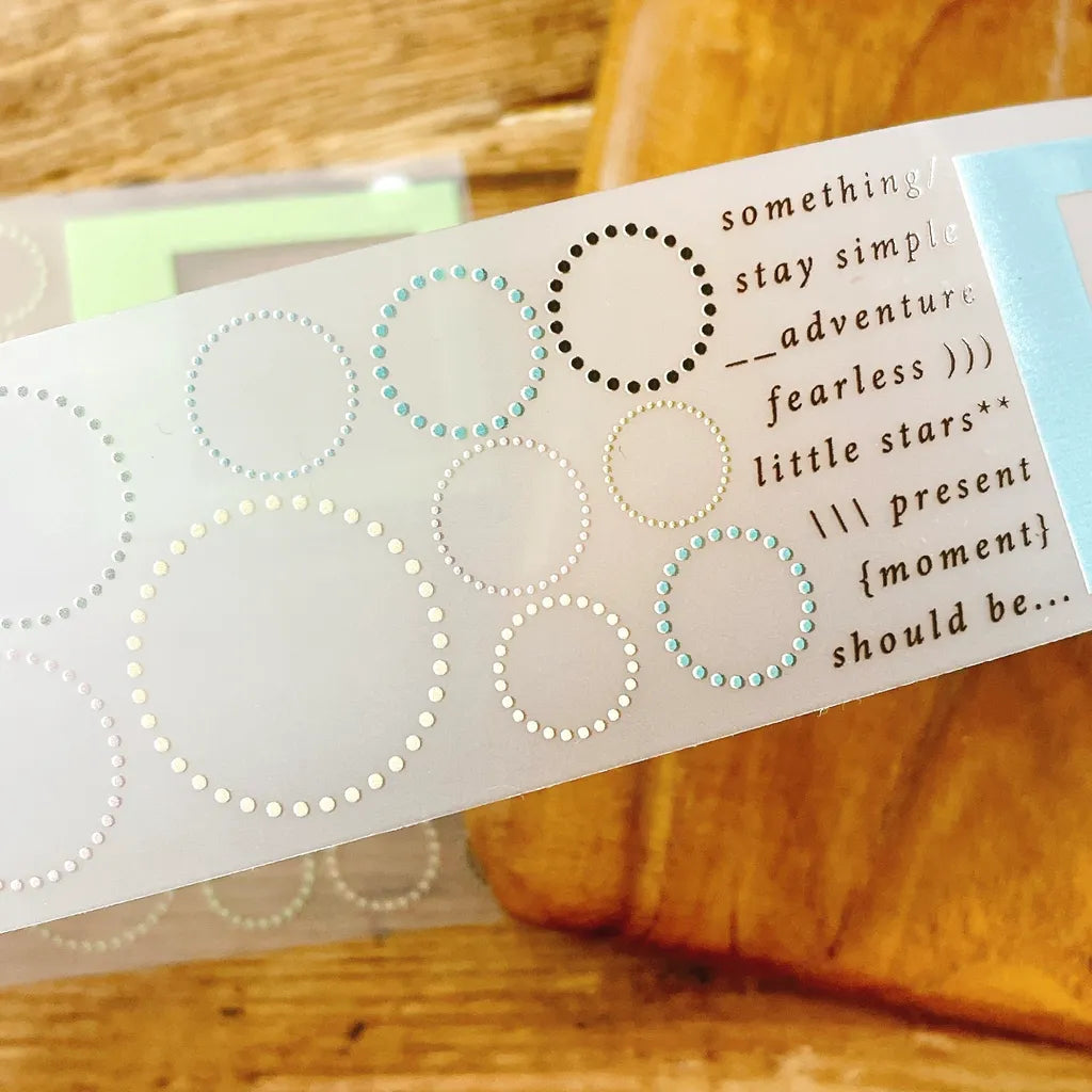 Full layout of Circle and Frame PET Tape strips with planner stickers and labels on wood