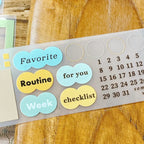 Organized display of multiple PET tape strips with frames, date numbers, and decorative circle stickers