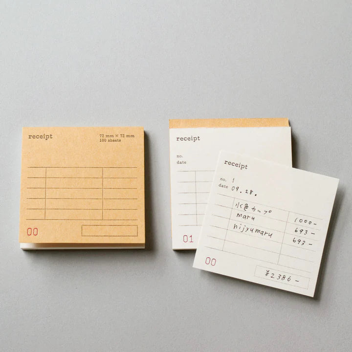 Three small notebooks labeled 'receipt' on a gray background