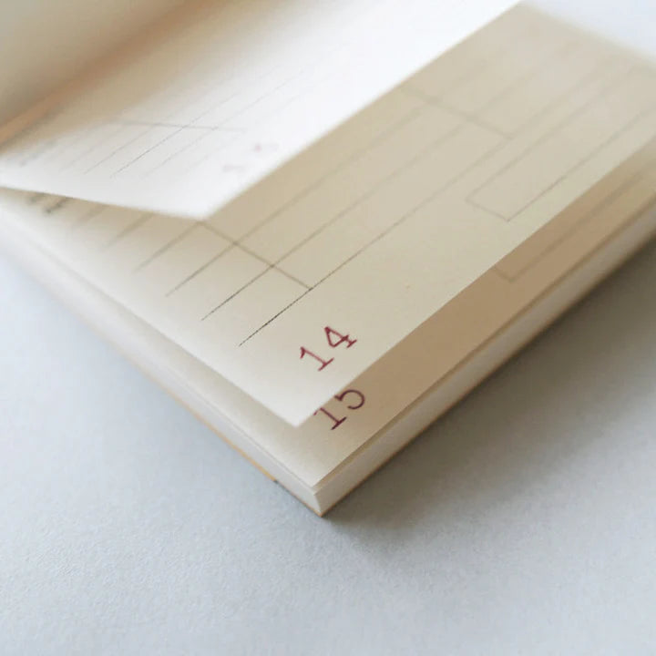 Close-up of a notebook with lined pages and a date stamp on a light background