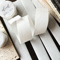 Rolls of washi tape with visible text on a textured surface