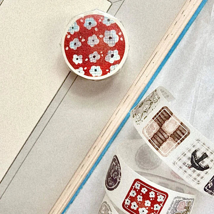 Decorative washi tape with floral pattern on a wooden surface